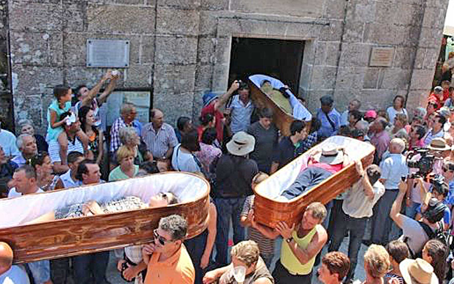 Festival of near death experiences marches through town with people in coffins